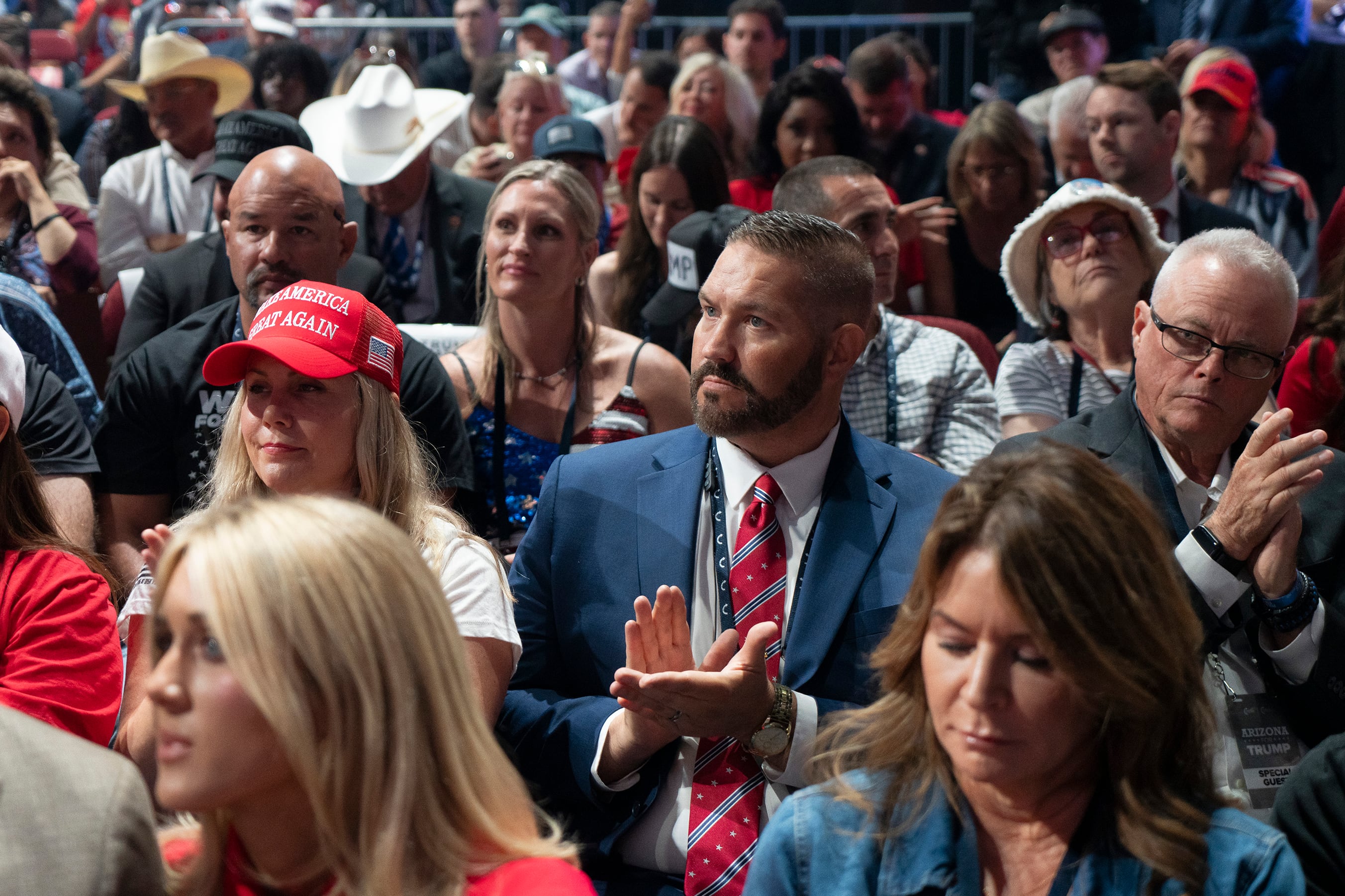 A group of people sitting in a large convention room.