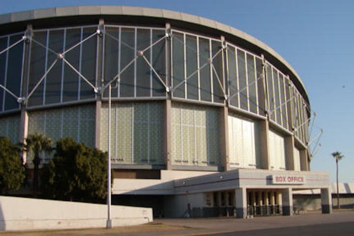 Exterior of round, steel-and-glass sports arena