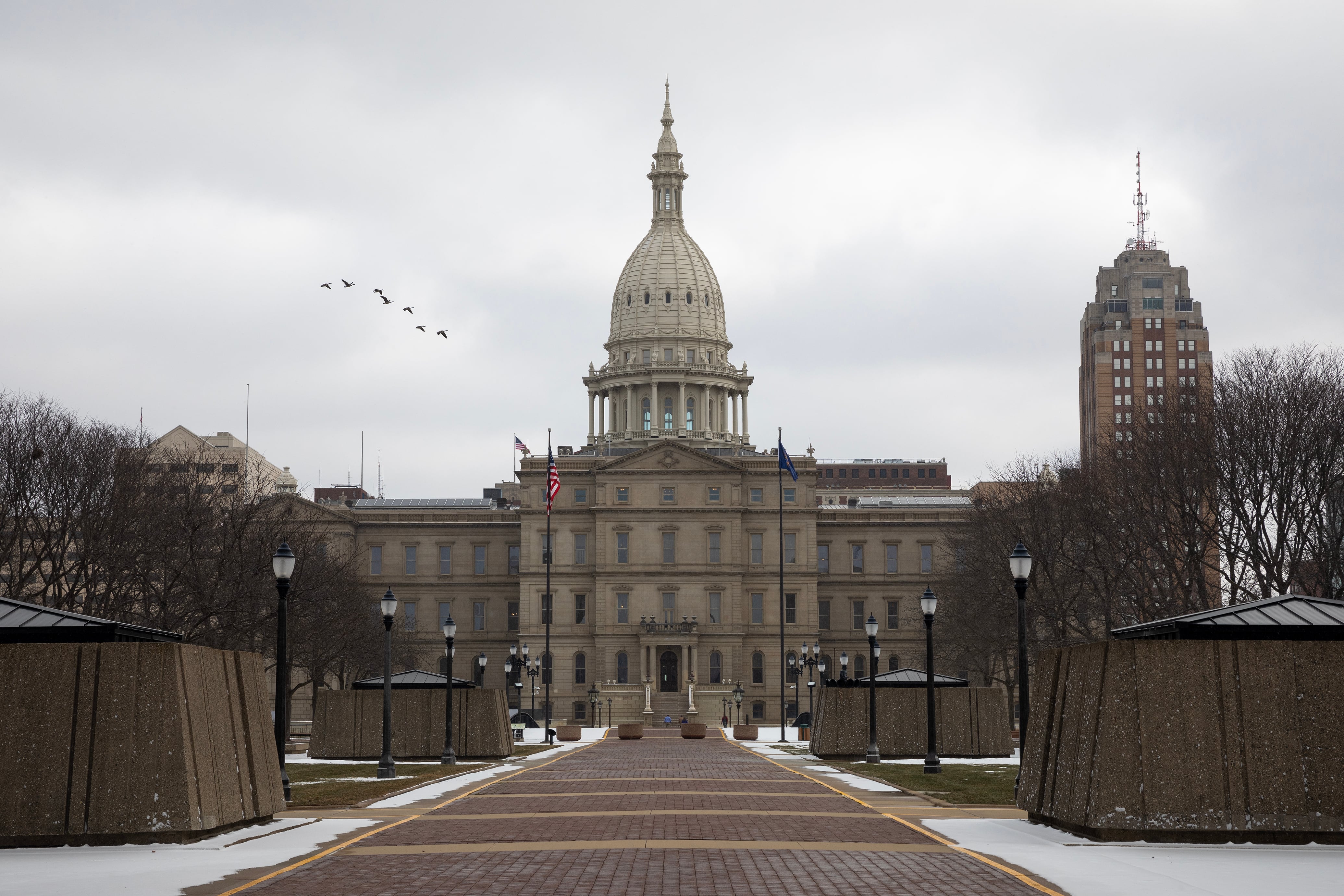 A large stone Capitol building on a cold, cloudy day.
