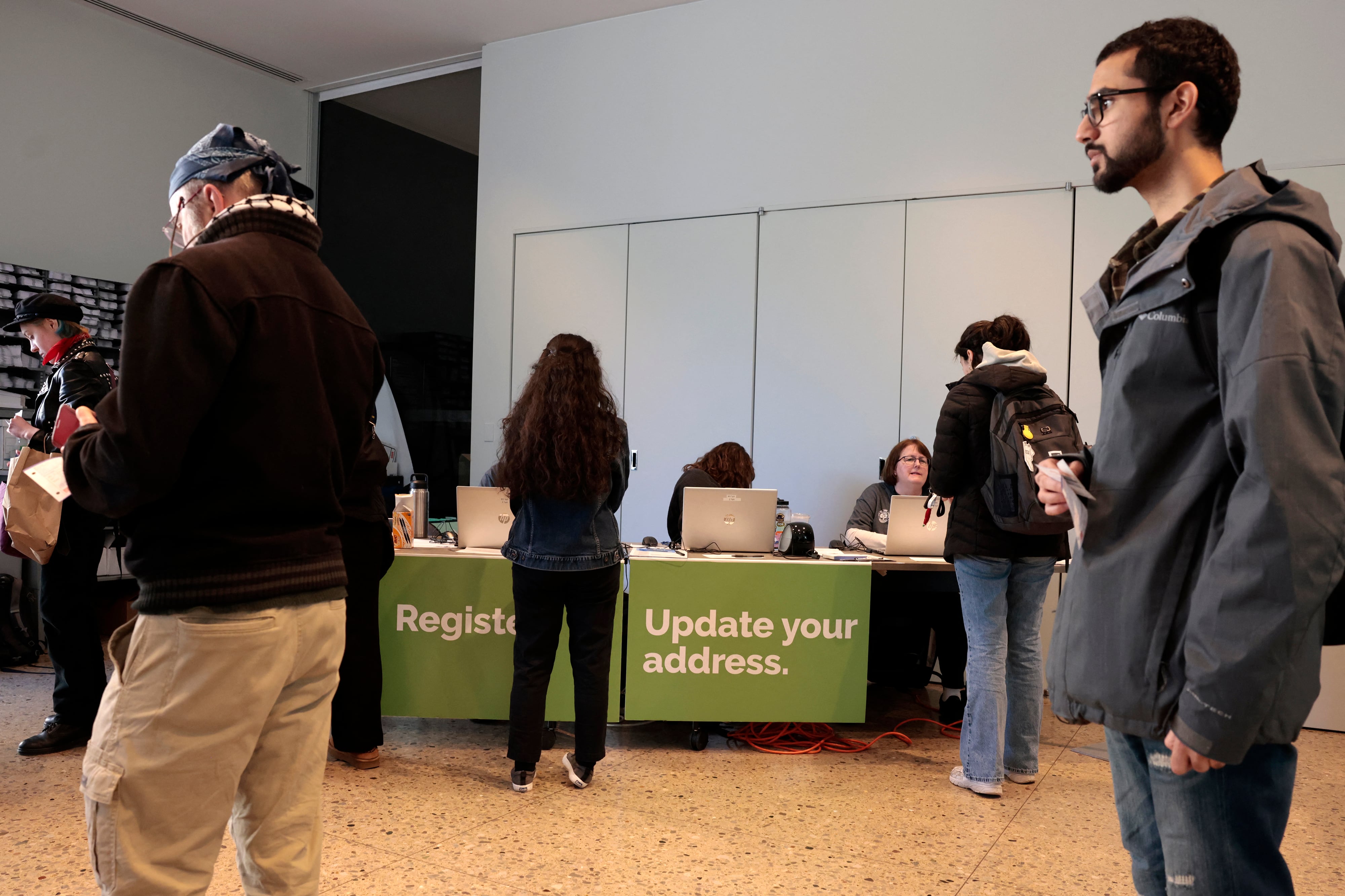 People stand waiting to vote.