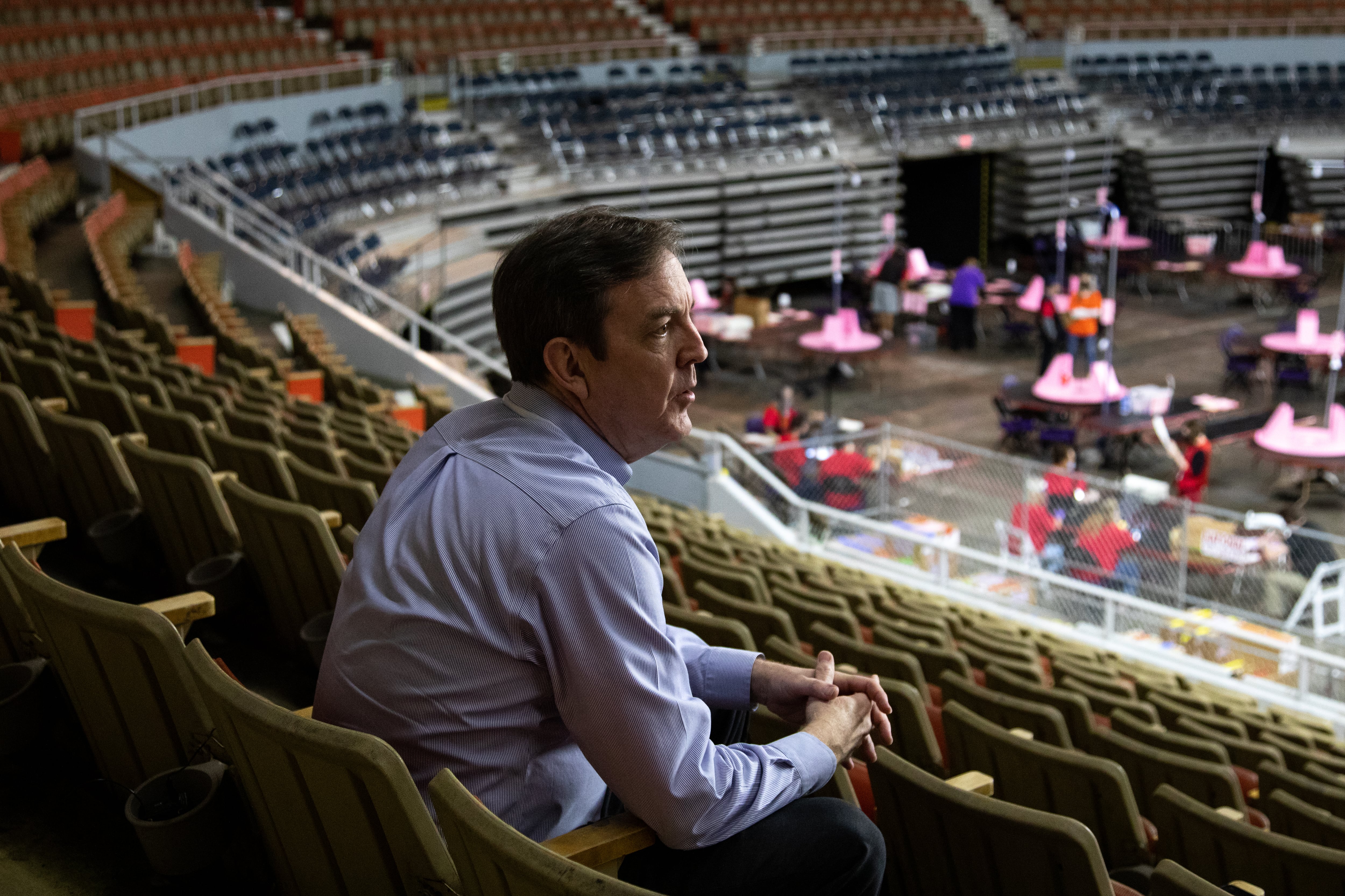 man sits in bleachers