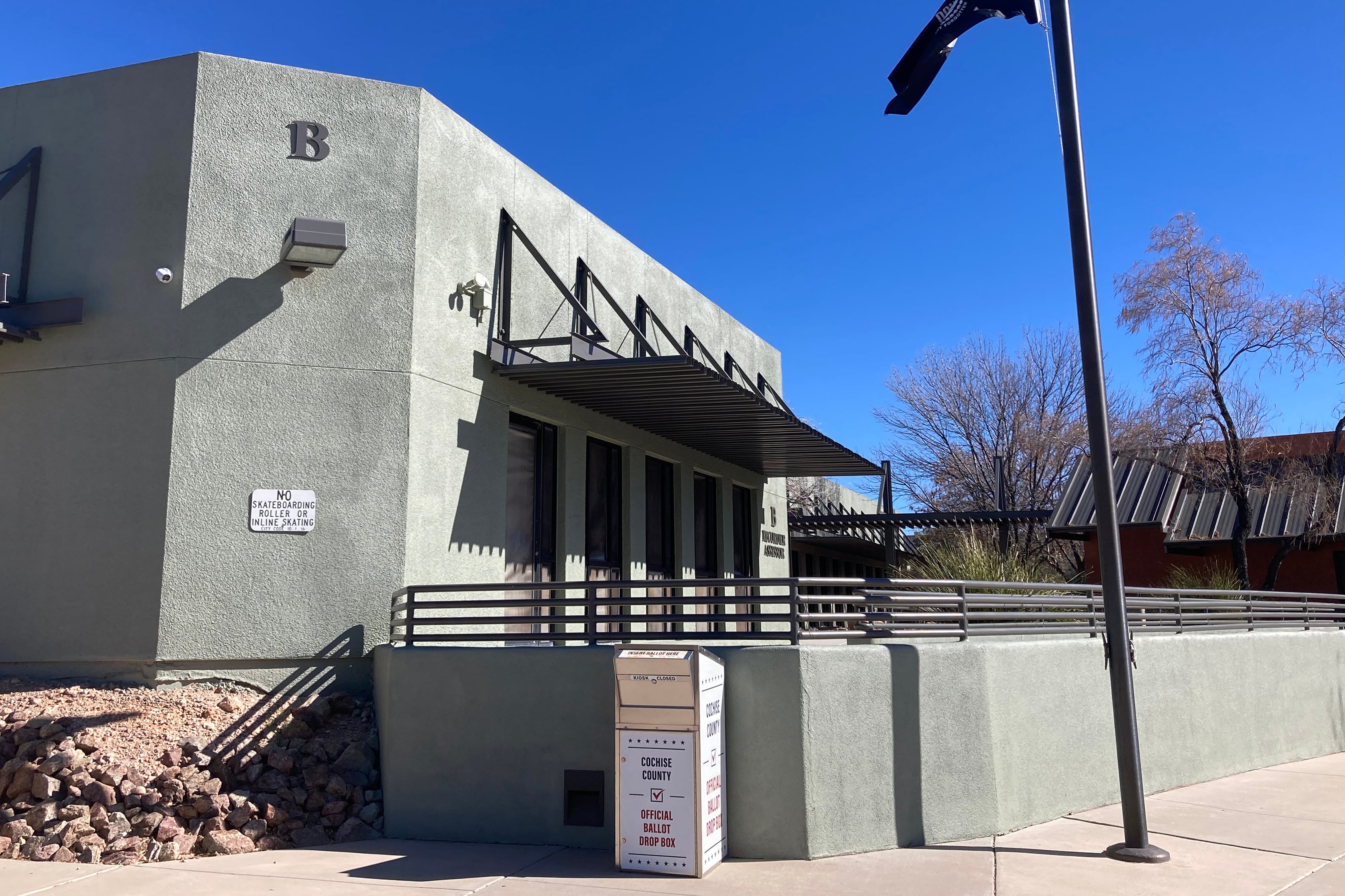 A green stone building outside.