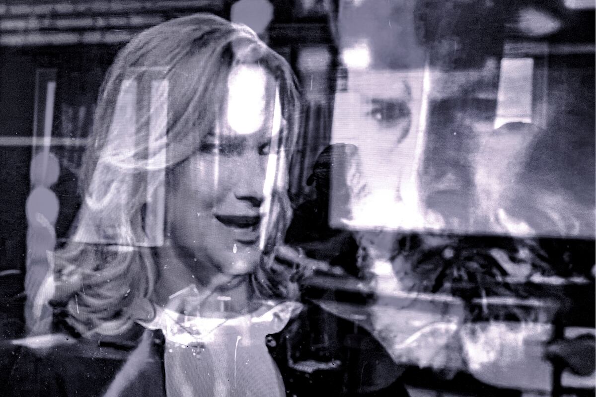 Black and white portraits of a woman with her head turned three-quarters of the way on the left and. a bearded man on the right.