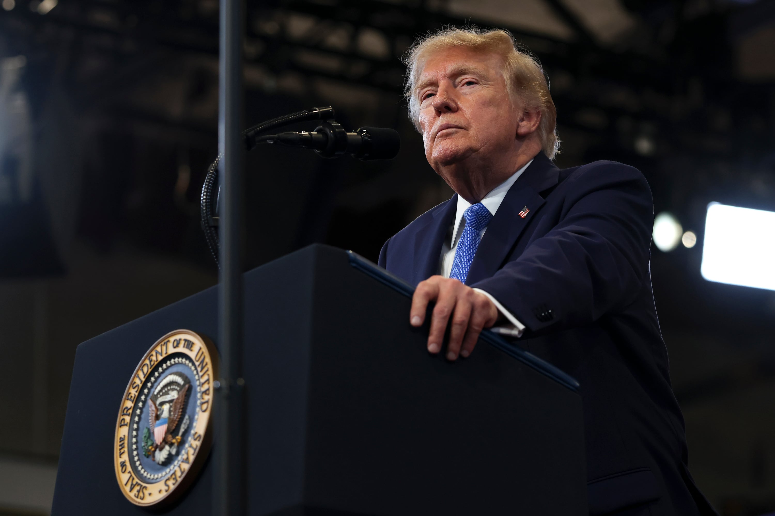 A white male is standing behind a podium