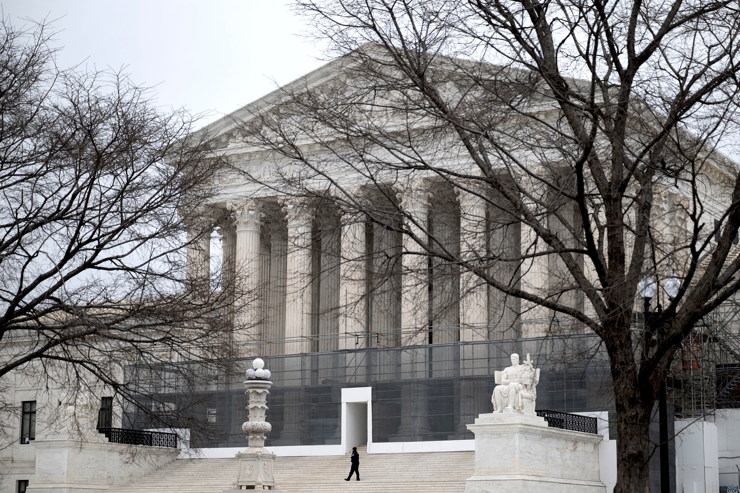 A photograph of the exterior of the United States Supreme Court building on a cold, grey day.