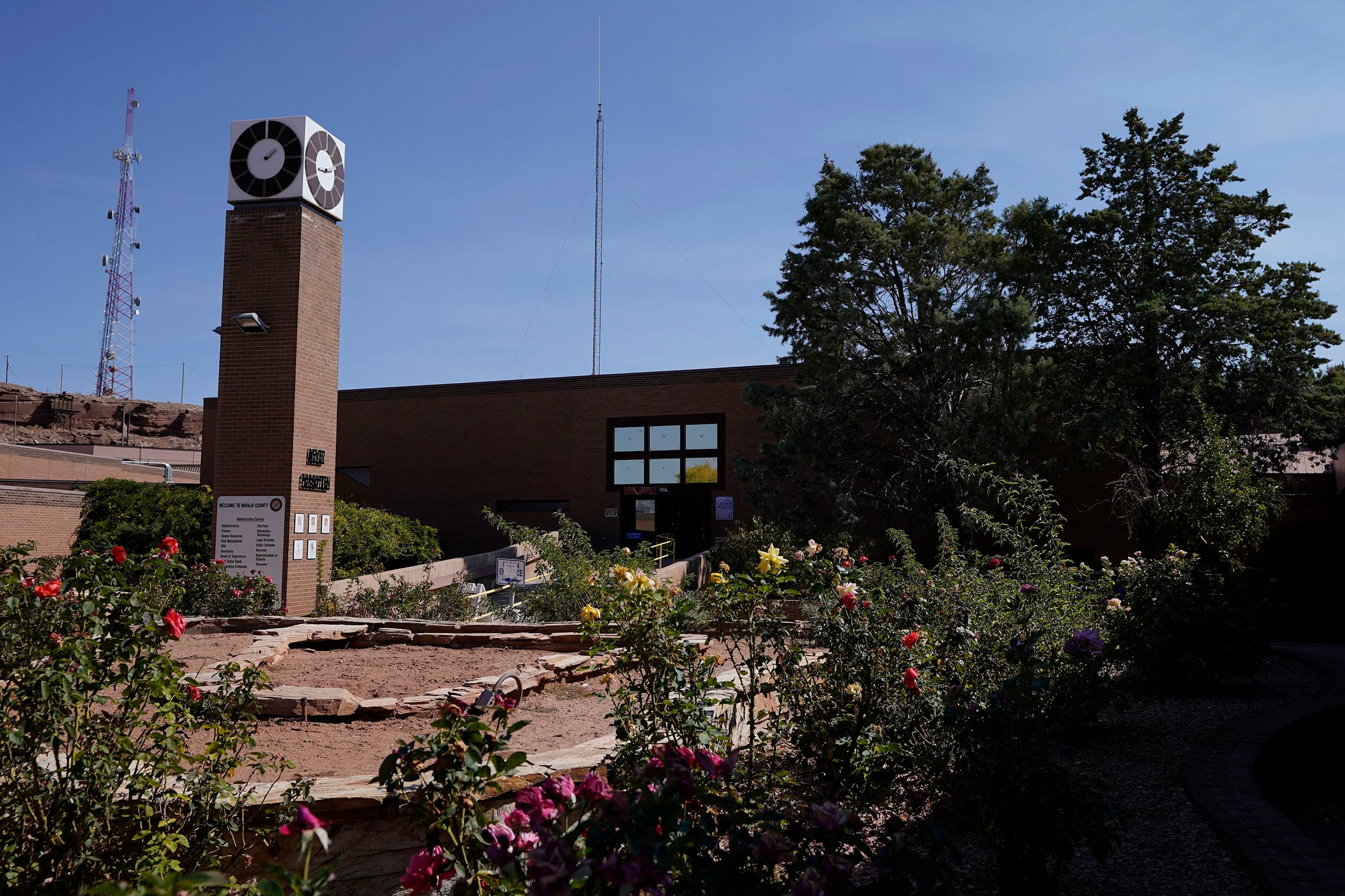 A photograph of the outside of a stone with lots of greenery around the outside.