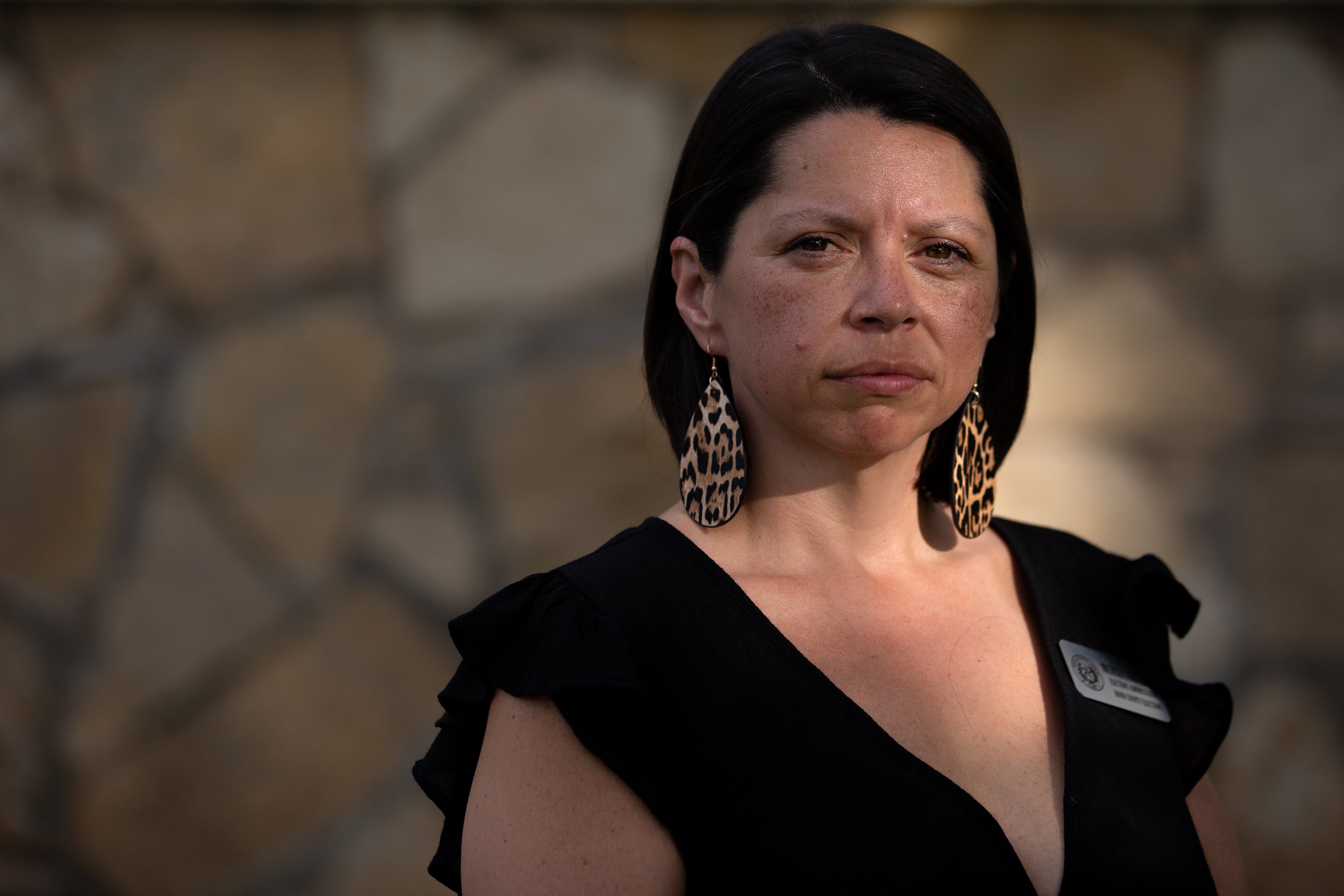 A woman poses for a portrait outside.