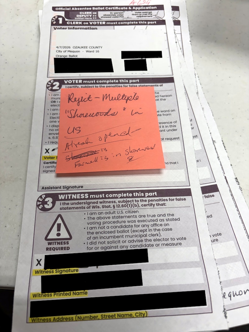 A photograph of a long, vertical piece of paper that is a form with black writing on it and an orange sticky note on the top.