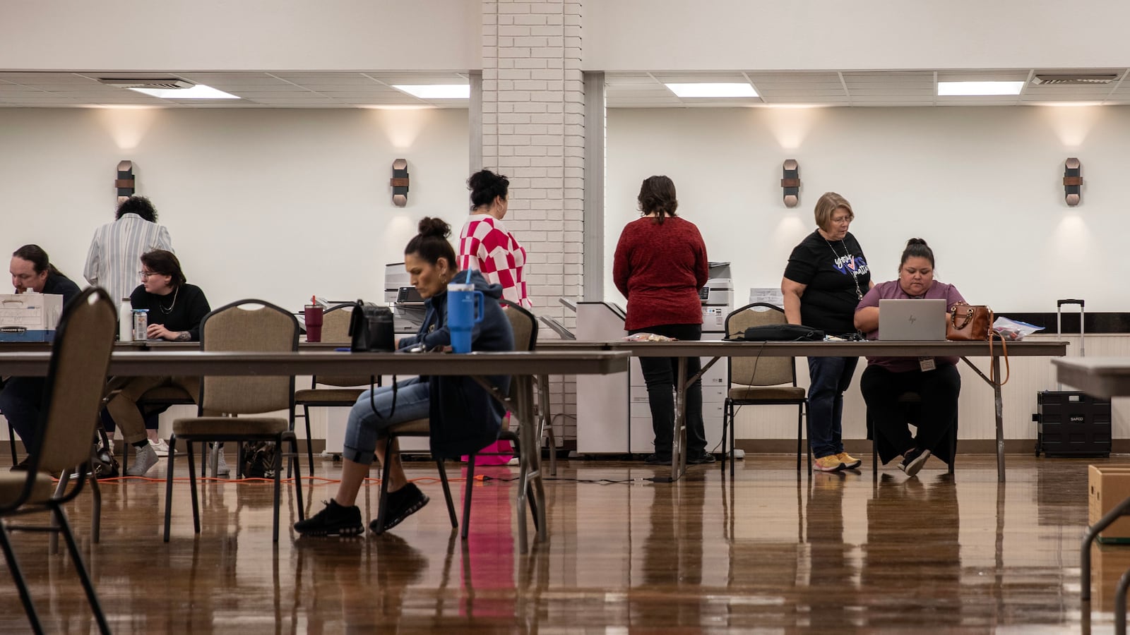 A group of people work in a conference room.