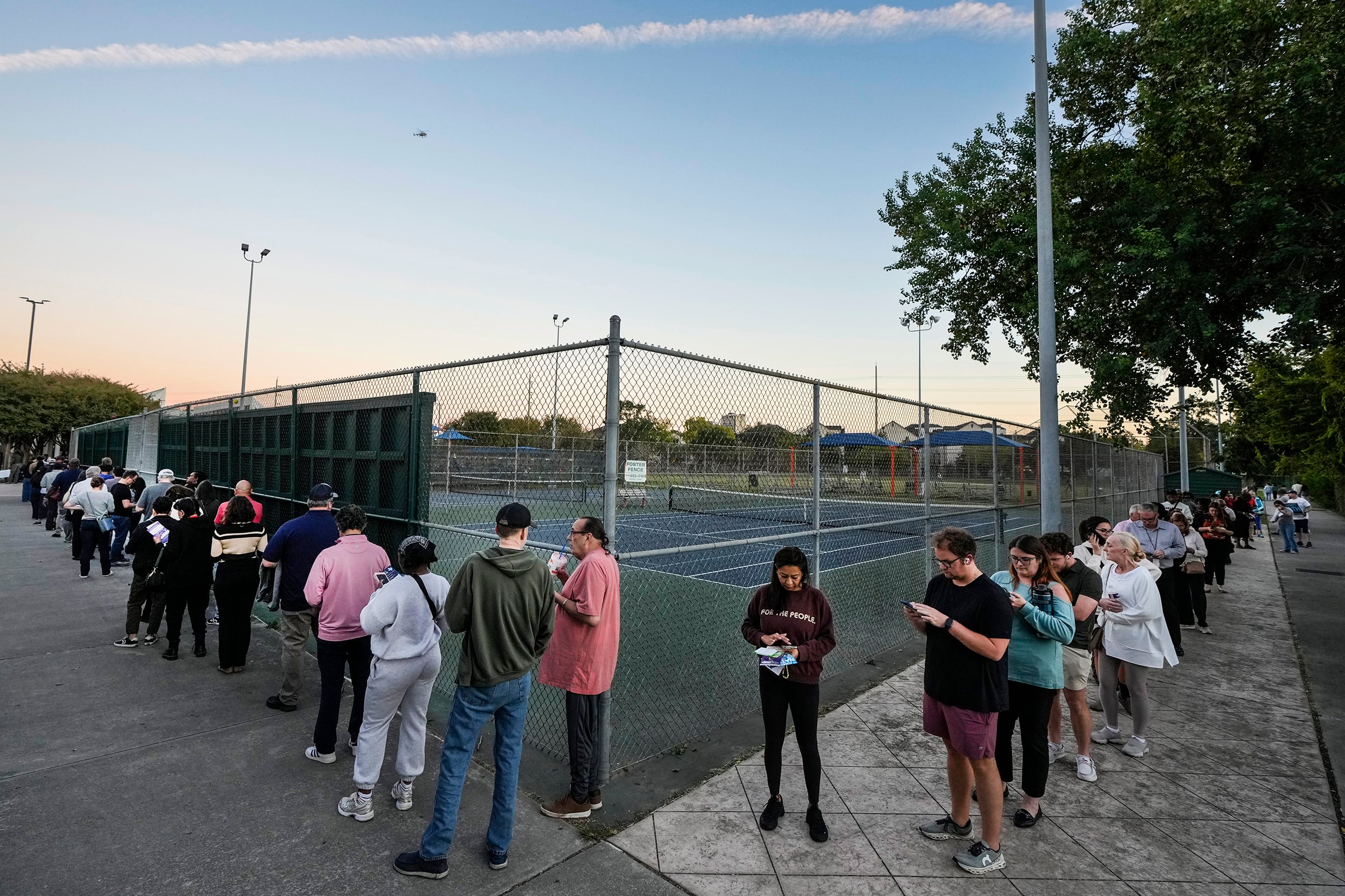 Voters wait in in line to cast their ballots in Houston