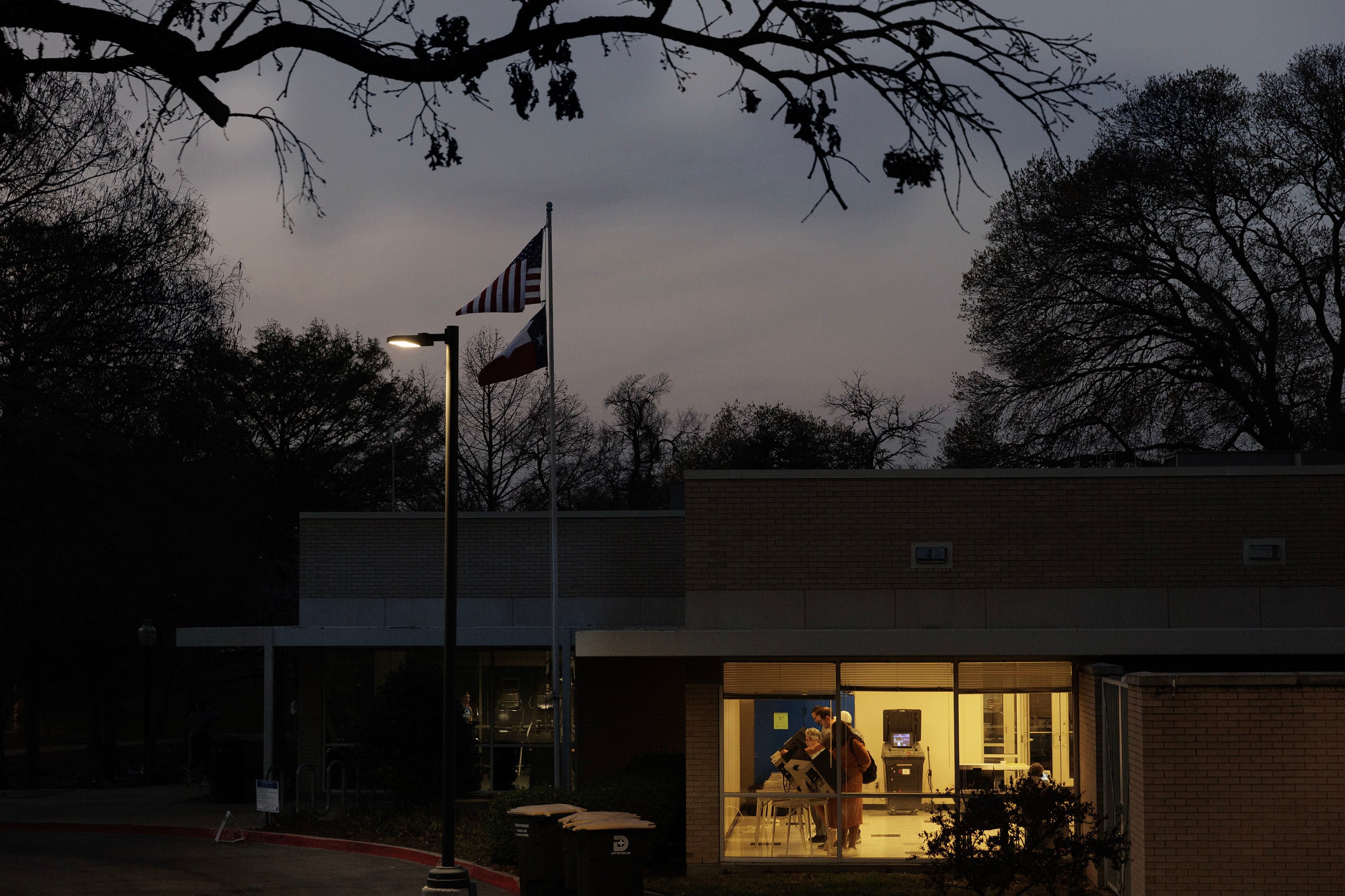 A polling place is lit up in the darkness.