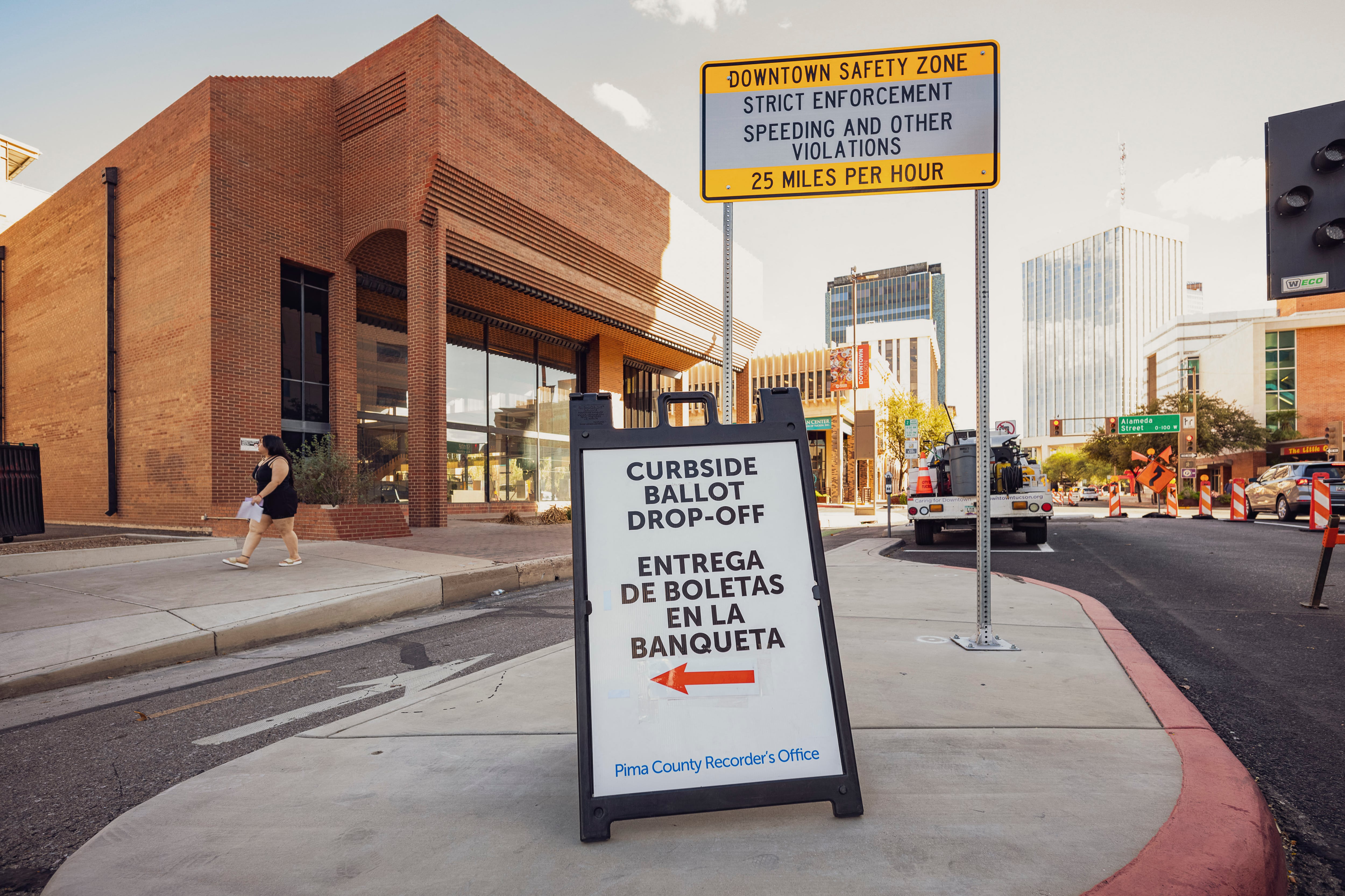 A svoting ign sits outside a building.