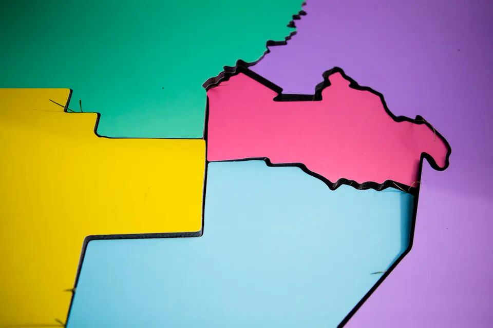 Closeup or colorful wooden pieces carved to fit into each other like puzzle pieces