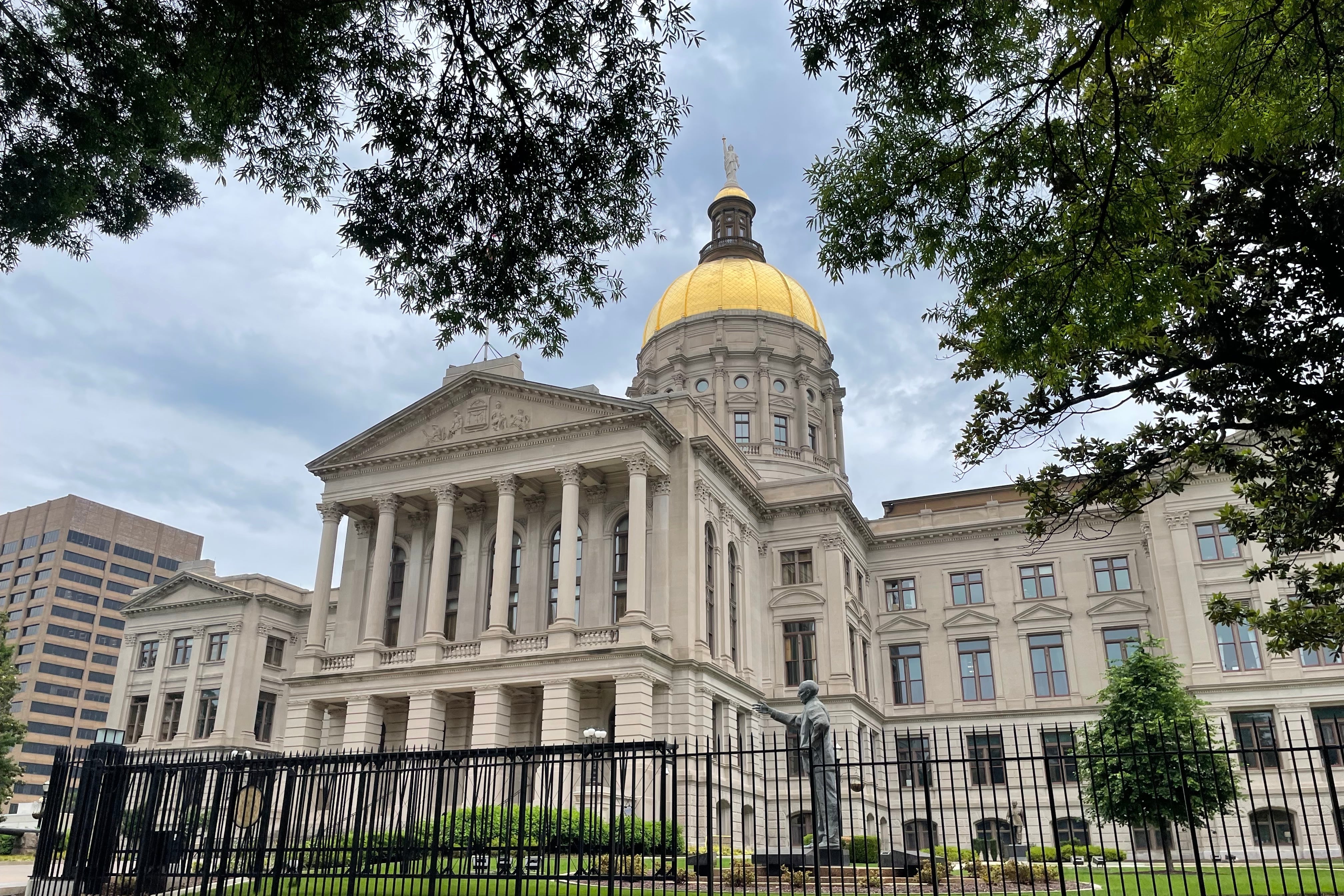 A tan building with a gold dome.