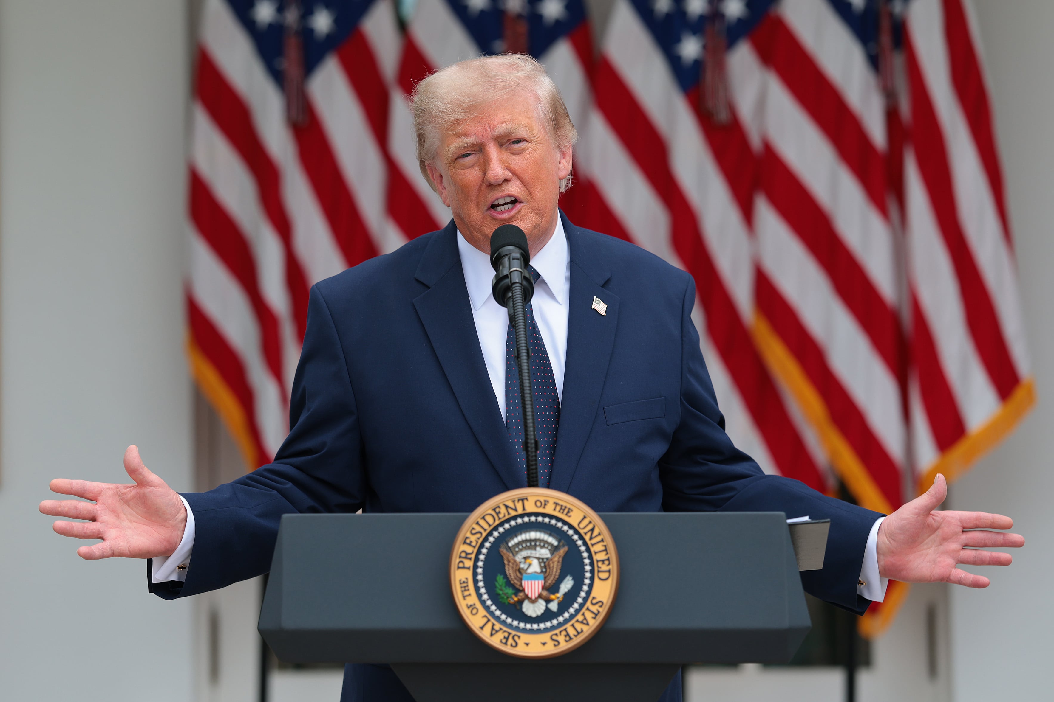 A white male is standing at a podium speaking.