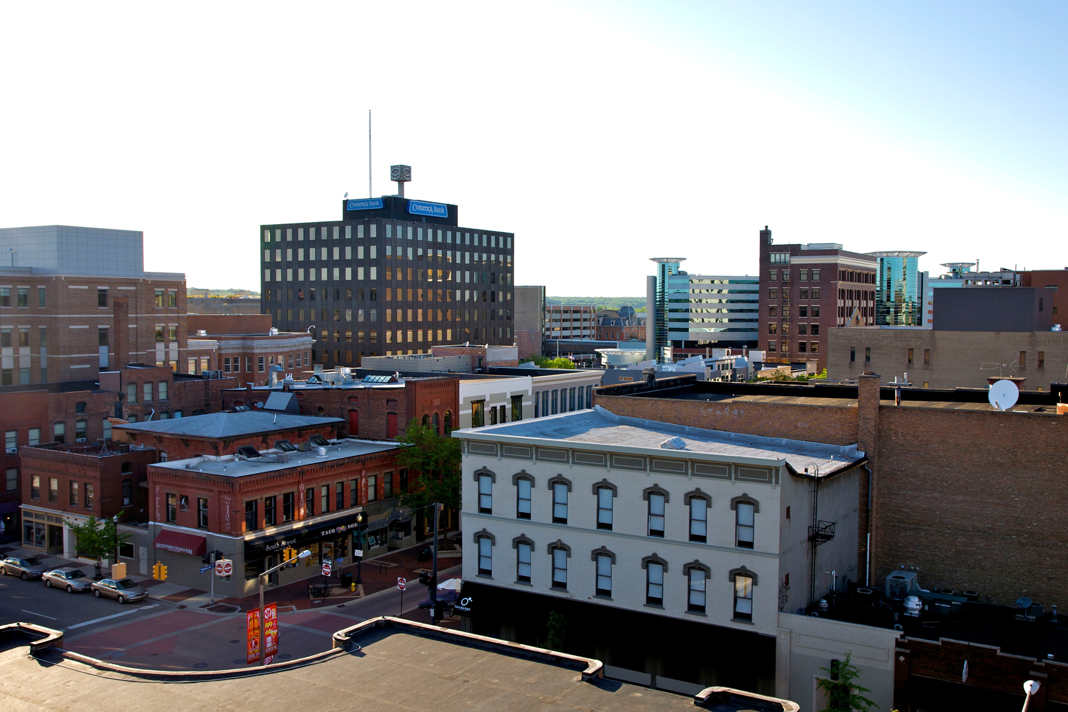 Aerial view of a small downtown with a bright sky.