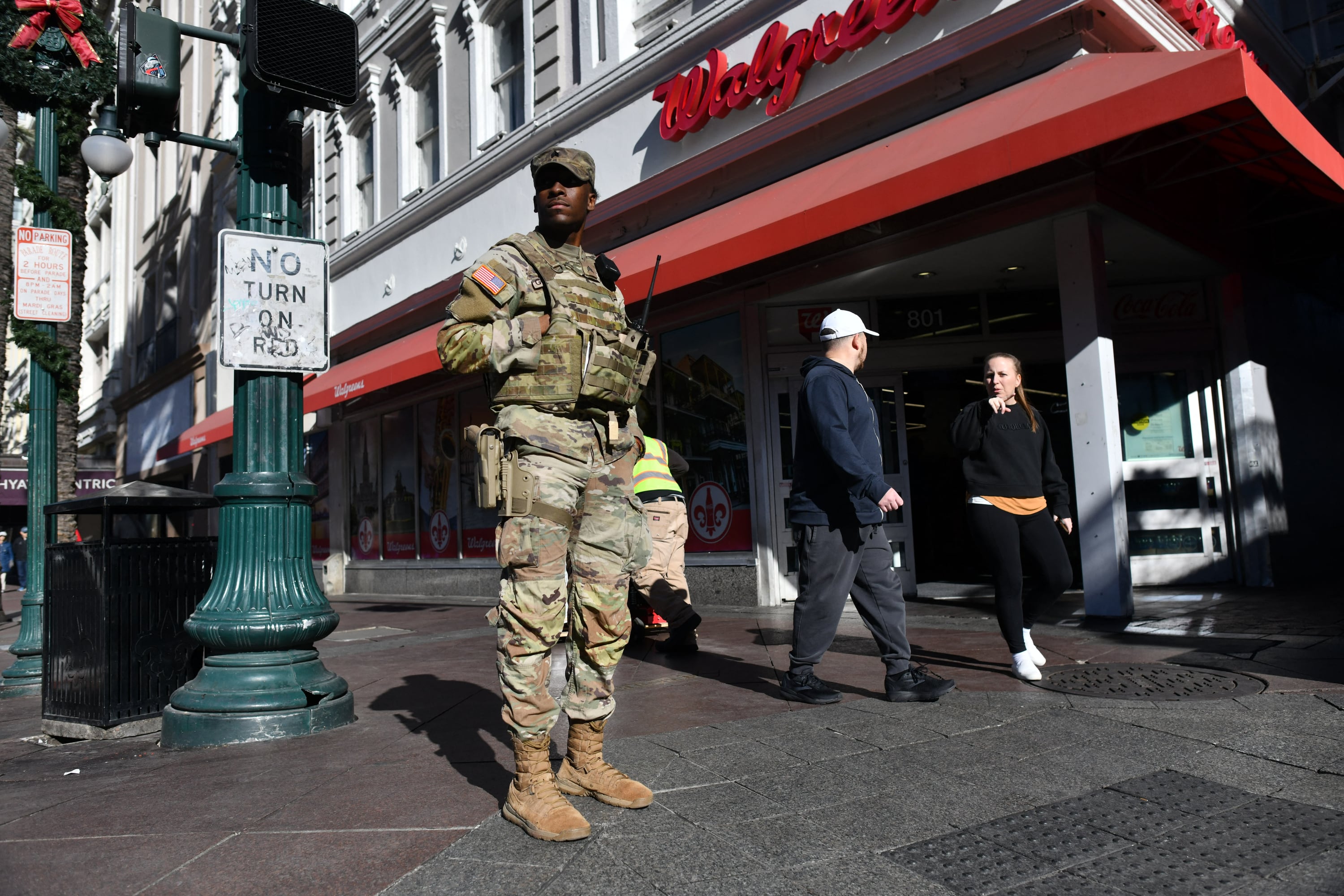 A man in fatigues stands outside a story.