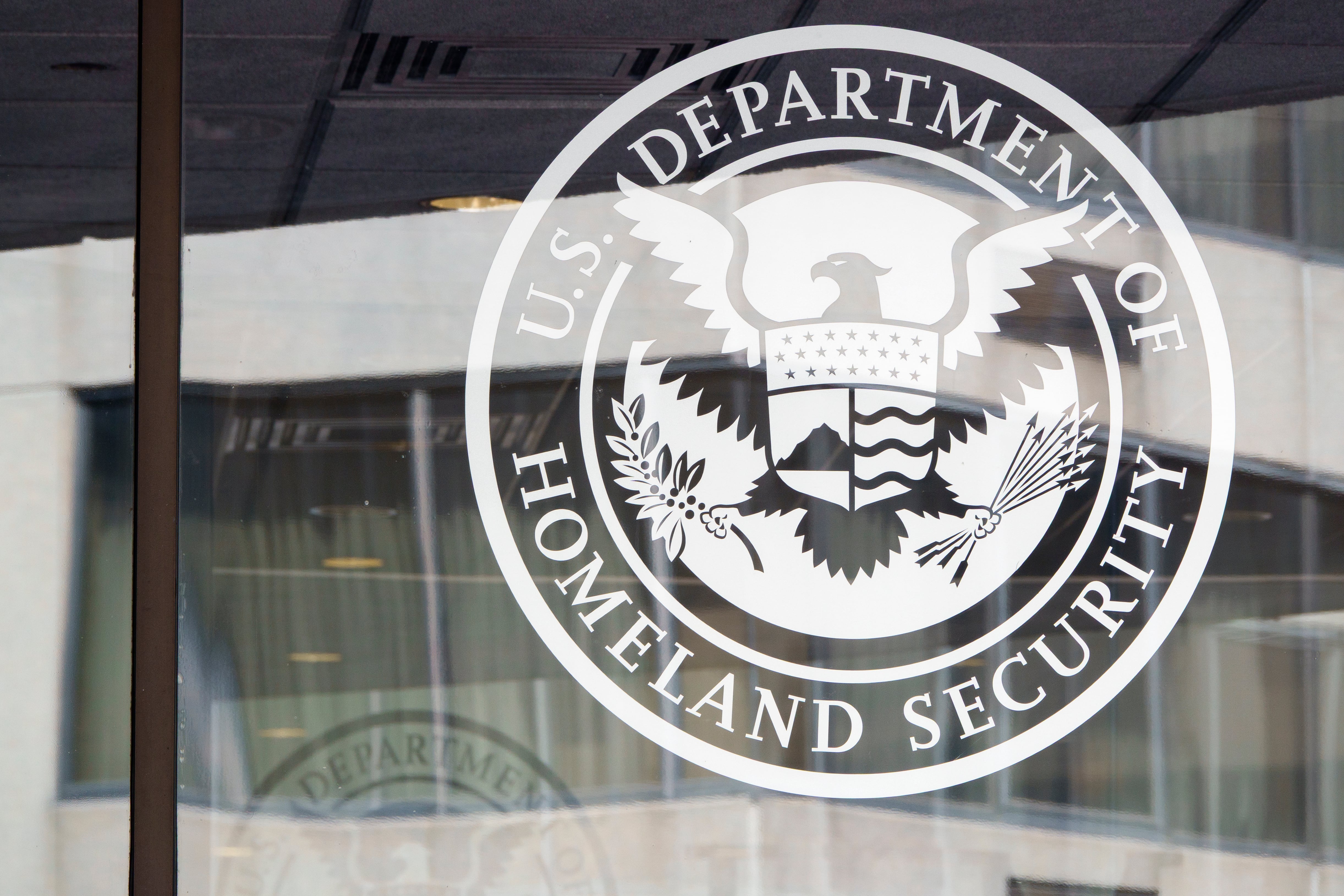 The DHS logo on the FEMA building. It is white on a gray background.